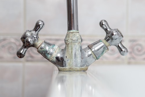A close up of limescale on a sink