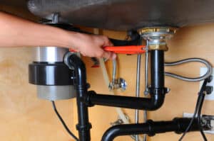 plumber fixes garbage disposal