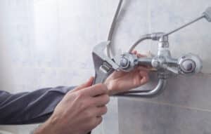 plumber repairing the shower fixture
