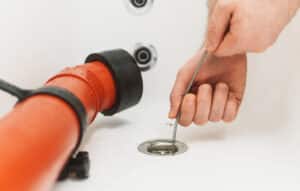 plumber snaking clogged drain