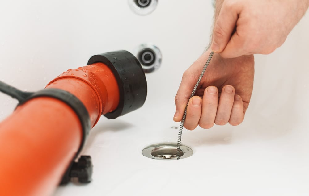 plumber snakes a drain