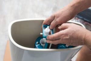 plumber installs a toilet