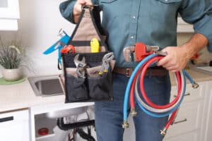 plumber holding tools