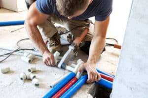 plumber connects pipes