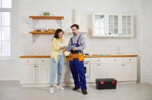 plumber discusses repairs with customer