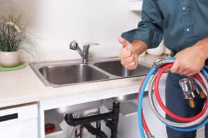 plumber holding drain cleaning equipment