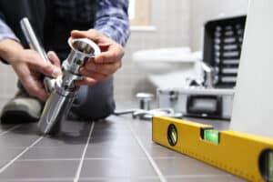 plumber repairs bathroom