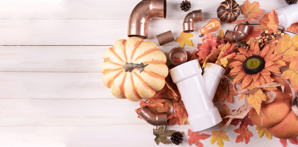Happy Thanksgiving with construction tools, maple leaves and pumpkin on wood background. Autumn composition with copy space. Plumber Thanksgiving. Top view.