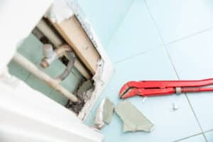 Hidden leaks in heating or watter supply can cause rot and other damage if left untreated. DIY, plumbing, water leak, home repair concept photo.