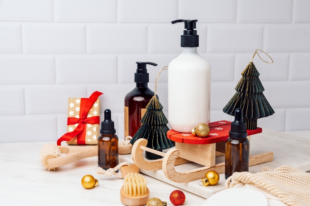 Gift set of skin and hair care products lotion, gel, shampoo, serum, massage brushes, cotton pads for makeup remover. Advent calendar, Christmas and New Year's gift 2023
