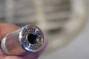 Sewer camera head close up. Sewer manhole on background. Shallow depth of field.