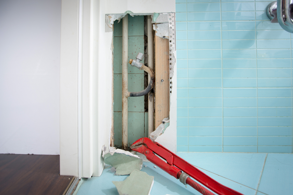 Hidden leaks in heating or watter supply can cause rot and other damage if left untreated. DIY, plumbing, water leak, home repair concept photo.